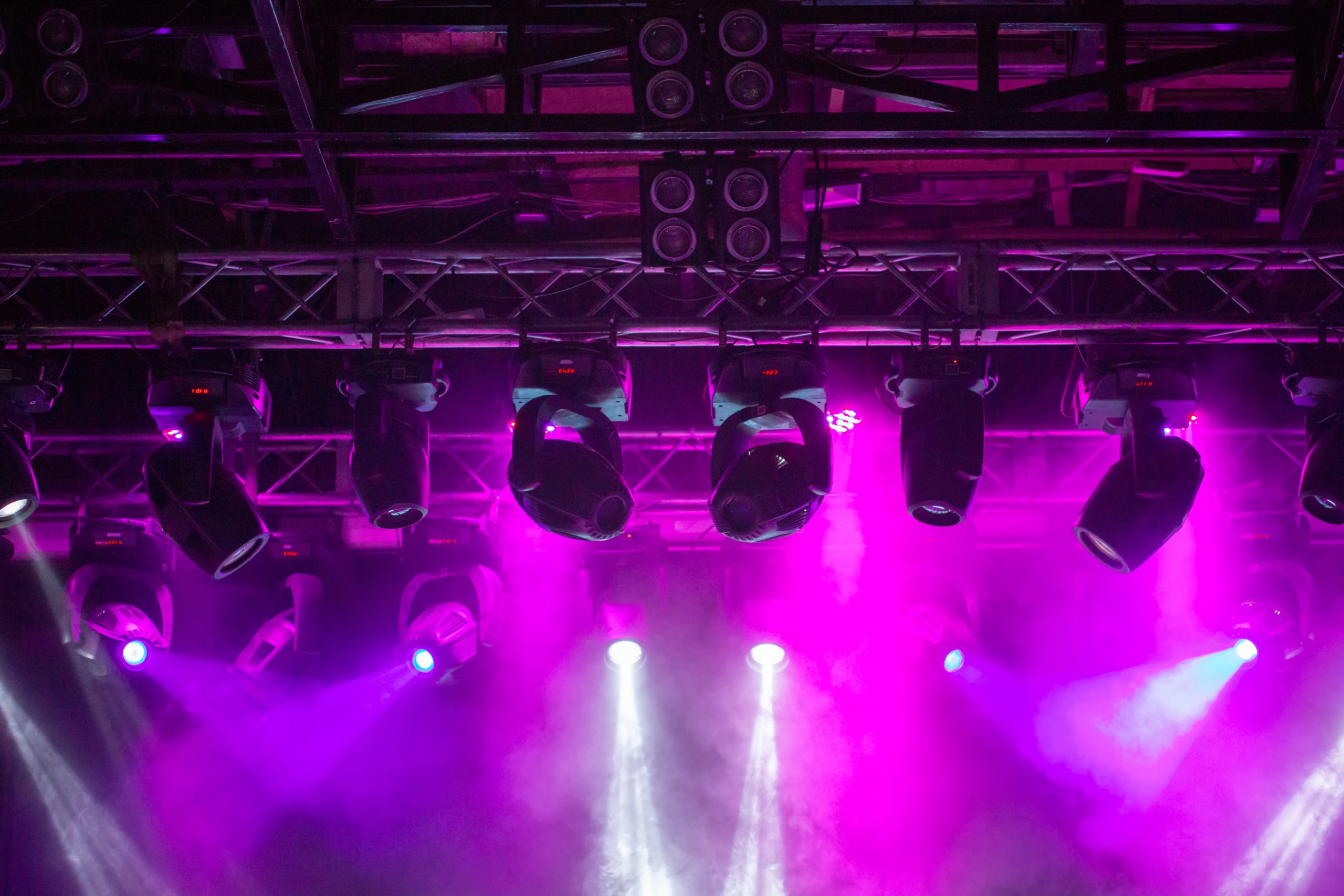 Stage, concert light. Modern spotlights equipment. Beautiful multicolored rays shine through the smoke.